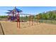 Community playground with swings and play structures within a fenced area at 12379 Turtle Grass Dr, Orlando, FL 32824