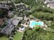 Stunning aerial view of the community clubhouse and pool, surrounded by lush landscaping and mature trees at 1303 Artisan E Ave, Celebration, FL 34747