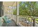 Charming balcony with seating area overlooking a serene tree-lined street at 1303 Artisan E Ave, Celebration, FL 34747