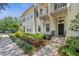 Inviting front exterior of a townhome featuring a well-manicured yard and sidewalk at 1303 Artisan E Ave, Celebration, FL 34747