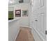 Hallway with carpet and closet doors with artwork on the wall at 1303 Artisan E Ave, Celebration, FL 34747