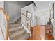Bright hallway features wood and carpet flooring, staircase with white railings, and a decorative light fixture at 1303 Artisan E Ave, Celebration, FL 34747