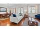 Inviting living room featuring hardwood floors, neutral decor, and a view into the dining area at 1303 Artisan E Ave, Celebration, FL 34747