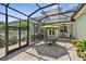 View of the enclosed patio with ample seating, plants, table and umbrella at 1303 Artisan E Ave, Celebration, FL 34747