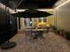 Screened in patio space with seating and lit umbrella in the evening at 1303 Artisan E Ave, Celebration, FL 34747