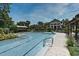 Large swimming pool with plenty of lounge chairs and lush landscaping in the background at 1303 Artisan E Ave, Celebration, FL 34747