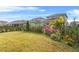 Manicured backyard with lush greenery, vibrant flowers, and a well-maintained lawn at 13282 Bromborough Dr, Orlando, FL 32832