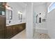 Modern bathroom features white herringbone tile, a glass-enclosed shower, and a double vanity at 13282 Bromborough Dr, Orlando, FL 32832