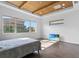 Bright bedroom features a wood-beamed ceiling, wood flooring, and large windows with views at 13282 Bromborough Dr, Orlando, FL 32832