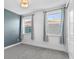 Bedroom features a blue accent wall and large windows providing an abundance of natural light at 13282 Bromborough Dr, Orlando, FL 32832