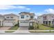 Two-story home featuring manicured landscaping, tile roof, two-car garage and neutral paint scheme at 13282 Bromborough Dr, Orlando, FL 32832