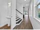 Bright foyer featuring wood-look floors, staircase, and a view into the living area at 13282 Bromborough Dr, Orlando, FL 32832