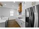 Modern kitchen with stainless steel appliances, white cabinets, and wood-look tile flooring at 13282 Bromborough Dr, Orlando, FL 32832