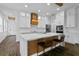 A kitchen with an island that provides seating, stainless appliances, and decorative lighting at 13282 Bromborough Dr, Orlando, FL 32832
