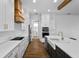 Bright kitchen with modern appliances, white cabinets, an island sink and a light wood range hood at 13282 Bromborough Dr, Orlando, FL 32832