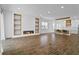 An open concept living room with a fireplace feature, hardwood floors and views of the kitchen at 13282 Bromborough Dr, Orlando, FL 32832