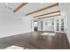 Large living room with wood floors, white walls, wood-beamed ceilings, and ample natural light at 13282 Bromborough Dr, Orlando, FL 32832