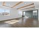 Spacious living room with wood floors, custom blue-gray cabinetry, and wood-beamed ceiling at 13282 Bromborough Dr, Orlando, FL 32832