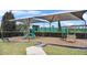 Community playground featuring slides, climbing structures, and shaded seating, fostering fun and safe play at 13282 Bromborough Dr, Orlando, FL 32832