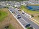 Aerial view of the community featuring a playground, pond, parking and landscaped homes at 1379 Winter Gray Cir, Deltona, FL 32738