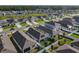 An aerial view showing the layout of the homes, landscaping, and a nearby pond at 1379 Winter Gray Cir, Deltona, FL 32738