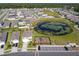 Aerial view of homes surrounding the playground, pond, and parking area within the community at 1379 Winter Gray Cir, Deltona, FL 32738