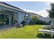 Spacious backyard features well-manicured lawn, landscaped border, and covered patio at 1379 Winter Gray Cir, Deltona, FL 32738