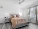 Cozy bedroom features a stylish bed with decorative pillows, complemented by elegant nightstands and lighting at 1379 Winter Gray Cir, Deltona, FL 32738