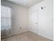 Simple bedroom featuring neutral carpet, a window with sheer curtains, and a white door at 1379 Winter Gray Cir, Deltona, FL 32738
