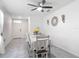 Bright dining room features tiled floors, decorative lighting, table with yellow flowers, and access to the main entrance at 1379 Winter Gray Cir, Deltona, FL 32738