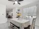 Bright dining area features a table set, sheer curtains, and view into the living room at 1379 Winter Gray Cir, Deltona, FL 32738