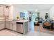 Open-concept kitchen featuring stainless steel appliances, a double sink, and views of the backyard and living room at 1379 Winter Gray Cir, Deltona, FL 32738