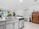 Well-lit kitchen island features stainless steel appliances and a view to the living area at 1379 Winter Gray Cir, Deltona, FL 32738