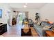 Cozy living room with hardwood floors, comfortable sofas, and sliding doors to the backyard at 1379 Winter Gray Cir, Deltona, FL 32738