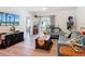 Cozy living room with wood floors, comfortable seating, and sliding door to the outside at 1379 Winter Gray Cir, Deltona, FL 32738