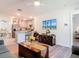 Open concept living room with modern kitchen and island and stainless steel appliances at 1379 Winter Gray Cir, Deltona, FL 32738