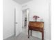 Bright office space featuring a charming desk with flowers and open access to the hallway at 1379 Winter Gray Cir, Deltona, FL 32738