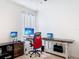 Bright office space with neutral walls, desk, and multiple computer setups for optimal productivity at 1379 Winter Gray Cir, Deltona, FL 32738
