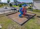 Community playground with colorful play structure and secure black fencing at 1379 Winter Gray Cir, Deltona, FL 32738