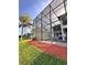 Expansive backyard with large screened in enclosure with pool and patio area at 1407 Water Lilly Ln, Kissimmee, FL 34744