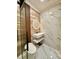 Bathroom showcasing a modern floating vanity, illuminated round mirror, and glass enclosed shower at 1407 Water Lilly Ln, Kissimmee, FL 34744