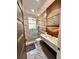 Stylish bathroom with marble flooring, modern vanity, a glass-enclosed shower, and a unique mirror at 1407 Water Lilly Ln, Kissimmee, FL 34744