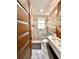 Stylish bathroom with marble flooring, modern vanity, a glass-enclosed shower, and a unique mirror at 1407 Water Lilly Ln, Kissimmee, FL 34744