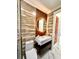 Elegant bathroom showcasing modern fixtures, statement mirror, glass shower, and marble floors at 1407 Water Lilly Ln, Kissimmee, FL 34744
