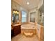 The bathroom features tile flooring, granite countertops, a soaking tub, and a walk-in shower at 1407 Water Lilly Ln, Kissimmee, FL 34744