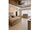 Spacious bedroom with a decorative ceiling fan, large windows, and elegant furnishings at 1407 Water Lilly Ln, Kissimmee, FL 34744