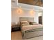 Bedroom featuring modern lighting, a decorative bed with throw blanket and an elegant design at 1407 Water Lilly Ln, Kissimmee, FL 34744