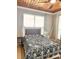Bedroom with paneled wood ceiling, a queen-size bed, and natural light from the window at 1407 Water Lilly Ln, Kissimmee, FL 34744