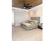 Bedroom with decorative fan, an elegant bed, wood-look floors, and ambient lighting at 1407 Water Lilly Ln, Kissimmee, FL 34744