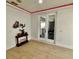 Stylish bonus room featuring a sleek console table and access to the backyard at 1407 Water Lilly Ln, Kissimmee, FL 34744